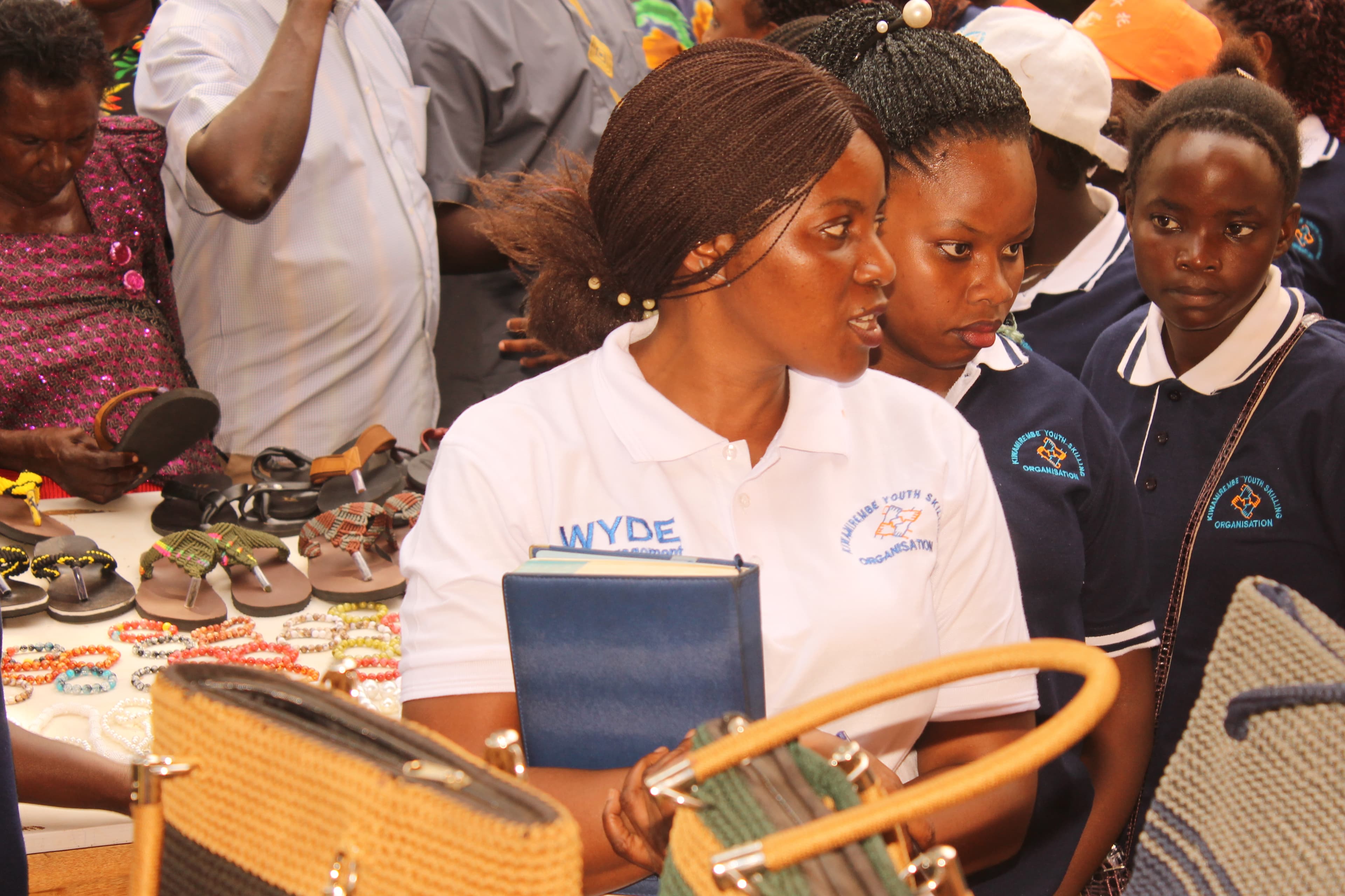 Project officer with trainees exhibiting the work done
